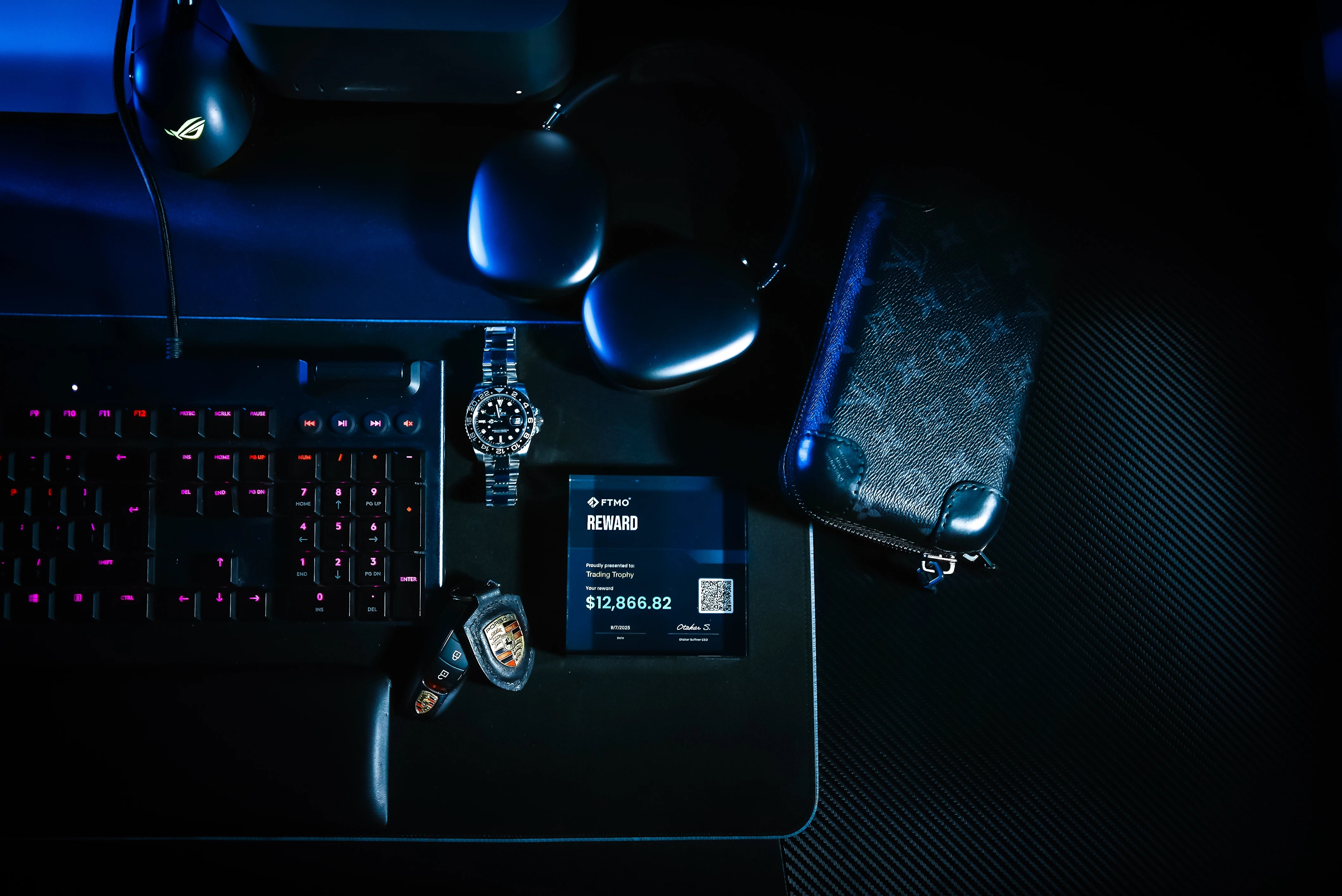 trading trophy with luxury rolex watch and key's porsche on table