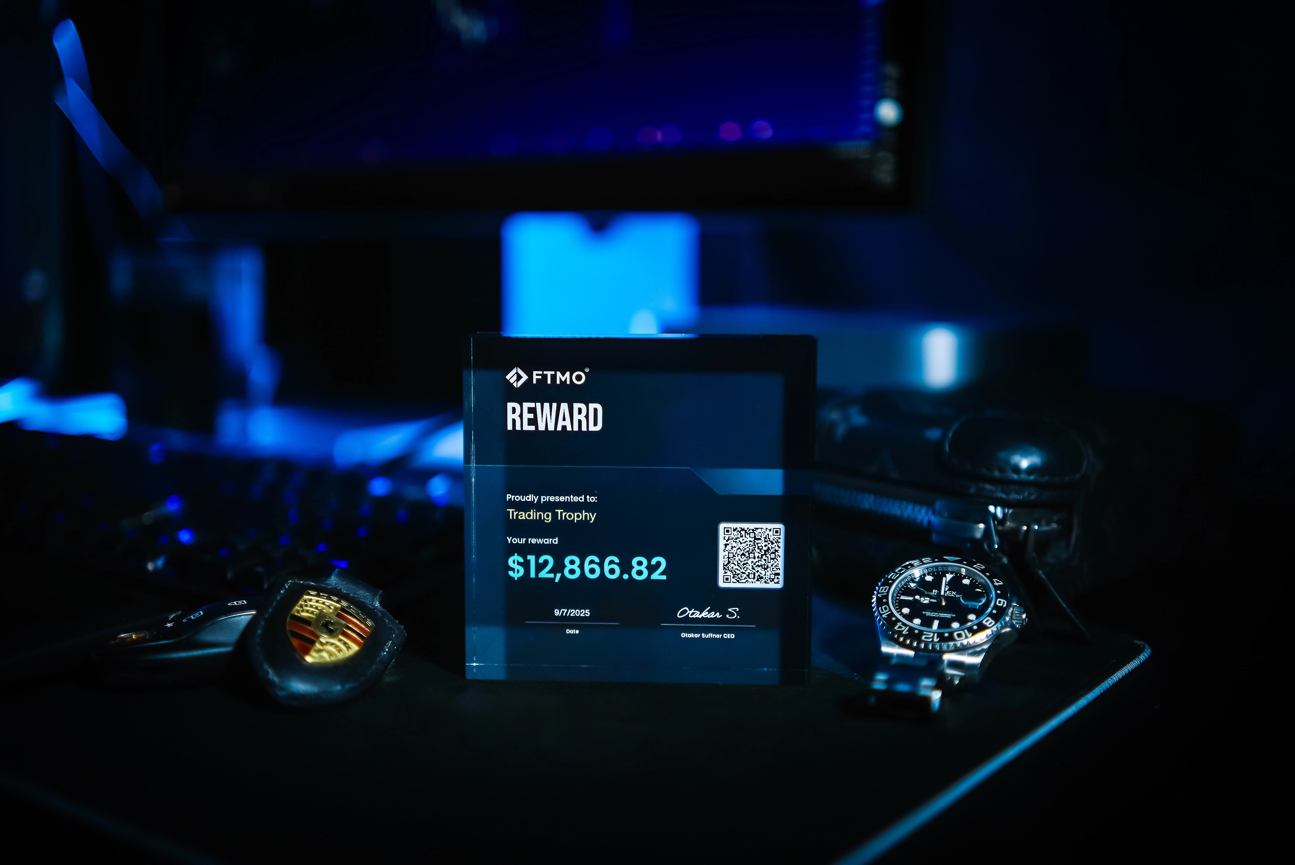 trading trophy with luxury rolex watch and key's porsche on table