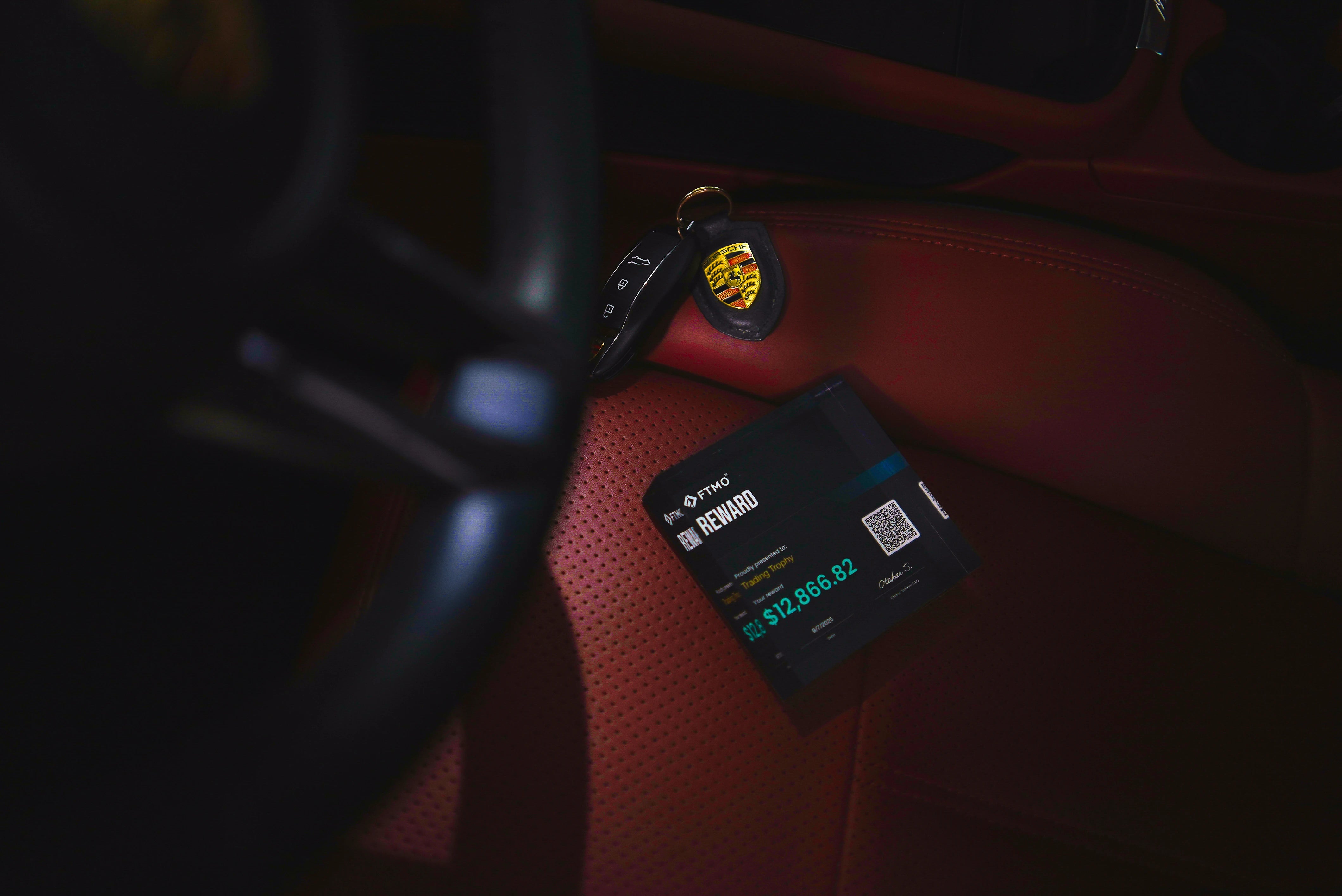 trading trophy and key's porsche in luxury car