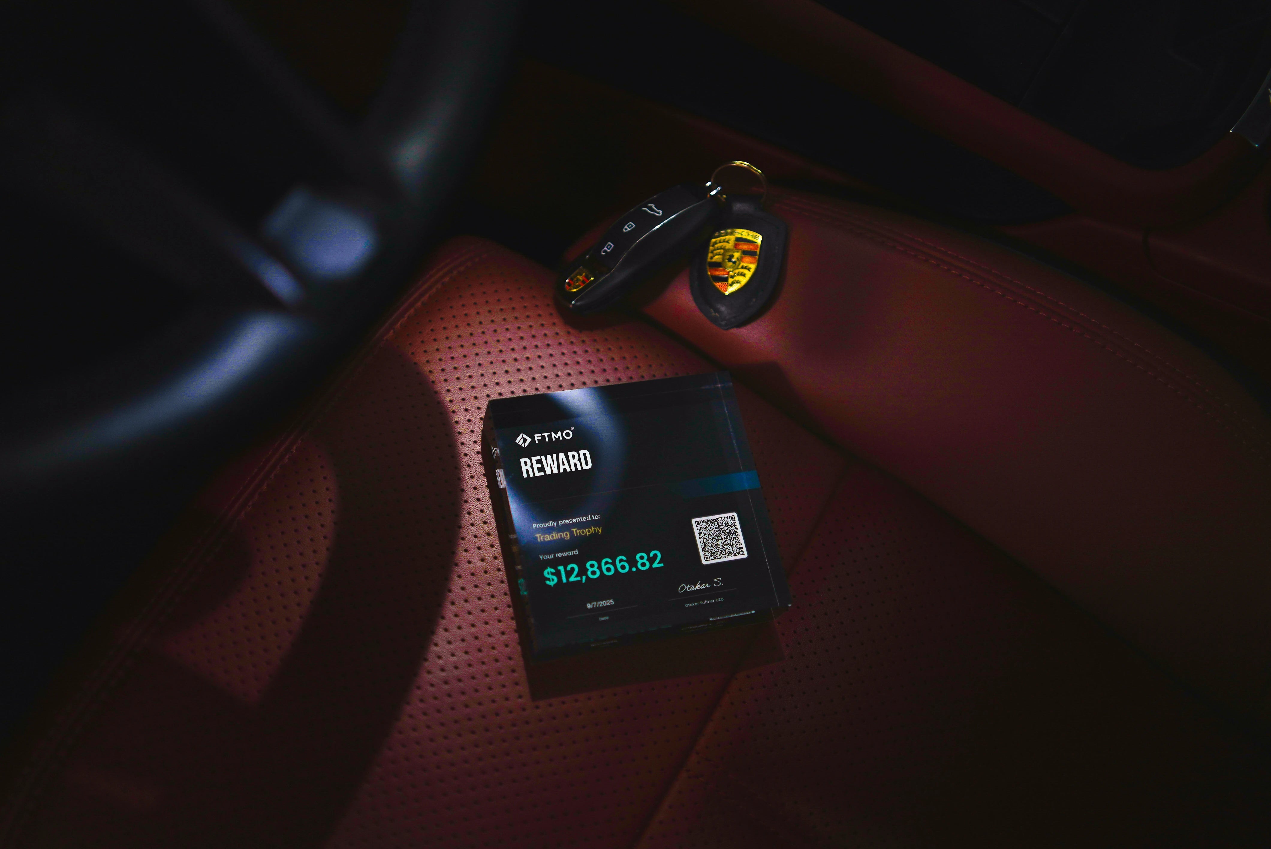 trading trophy and key's porsche in luxury car
